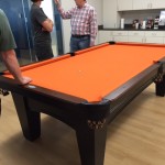 Handsome pool table covered with Avast orange